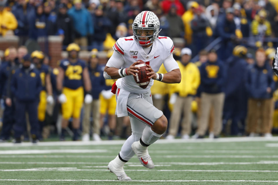 Ohio State quarterback Justin Fields (1) rolls out to throw against Michigan in the first half of an NCAA college football game in Ann Arbor, Mich., Saturday, Nov. 30, 2019. (AP Photo/Paul Sancya)