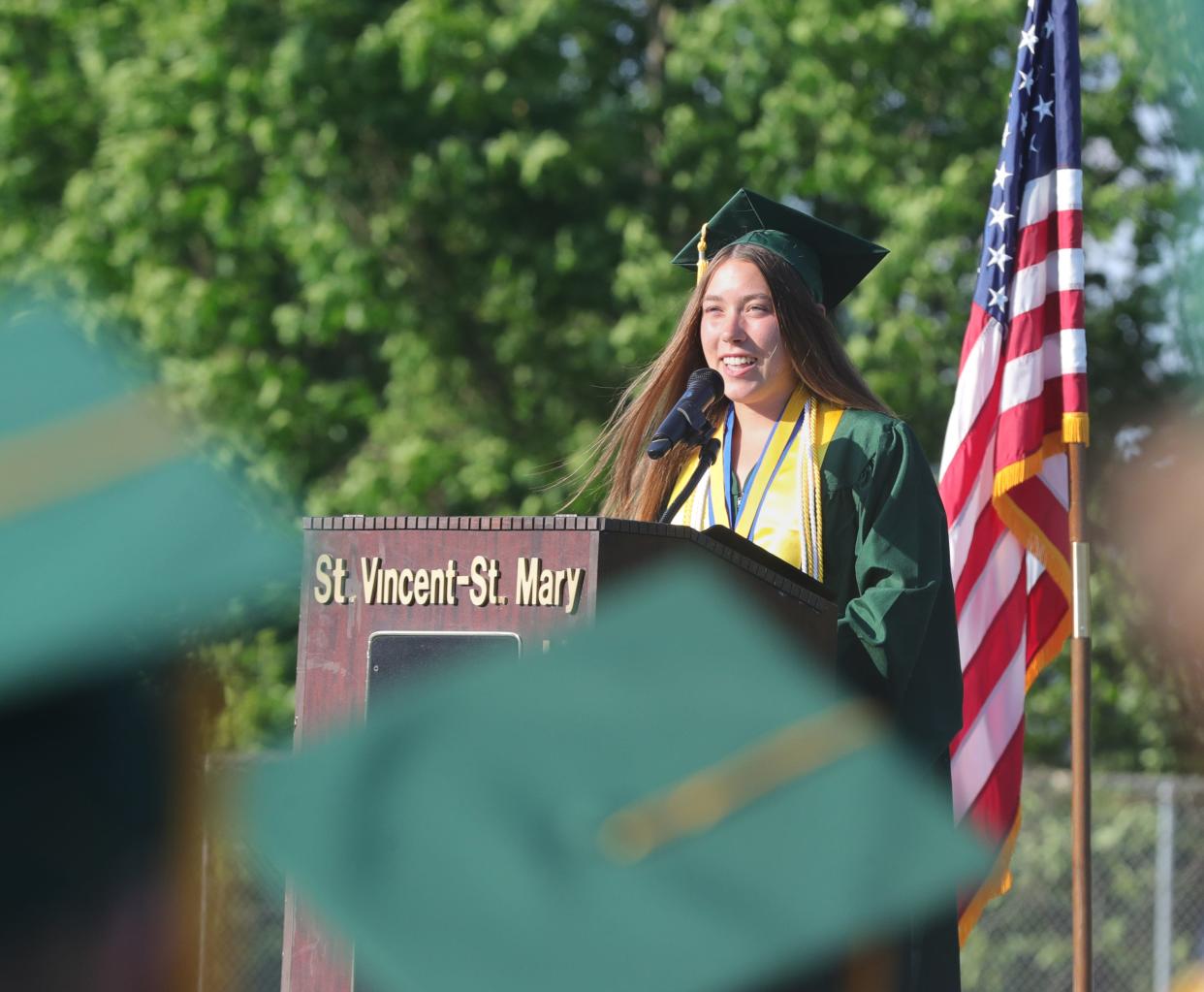 St. Vincent-St. Mary valedictorian Anne Rea gives her speech to the class of 2024 on Tuesday, during graduation. Rea's family home in Bath was destroyed by a fire the night before her graduation