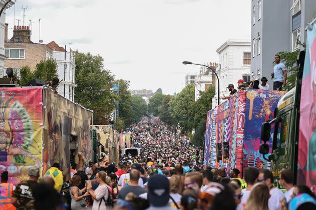 Millions of attendees walk along the parade route at Notting Hill Carnival, alongside floats. (Photo: Clara Watt for HuffPost)