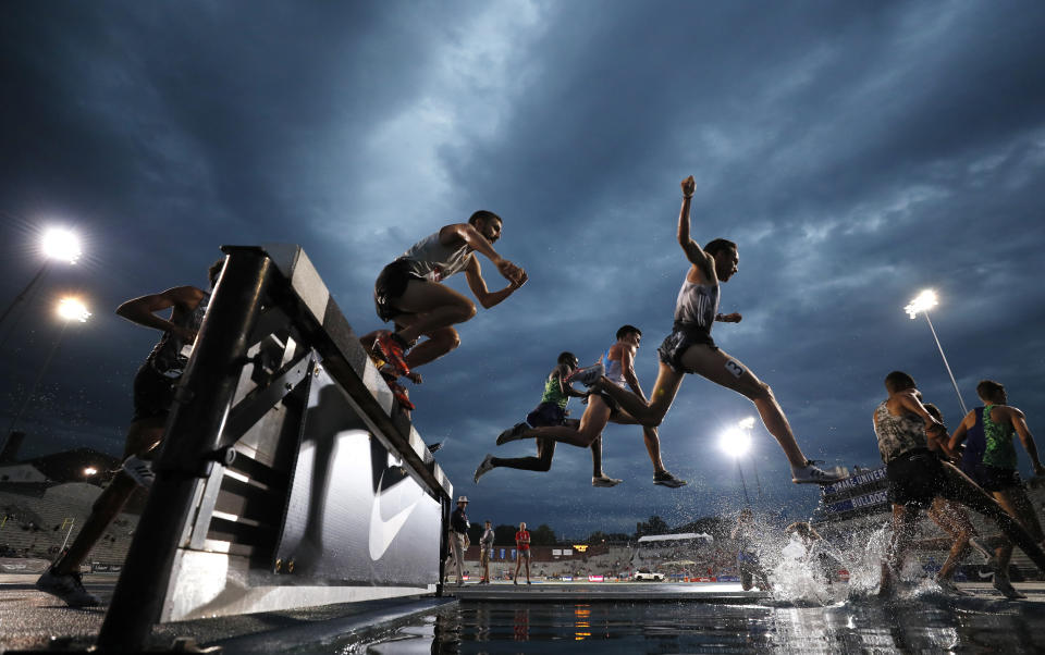 Competitors leap over the water pit during a preliminary heat in the men's 3,000-meter steeplechase at the U.S. Championships athletics meet, Thursday, July 25, 2019, in Des Moines, Iowa. (AP Photo/Charlie Neibergall)