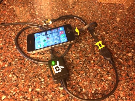 An iPhone being charged by a PowerPot V thermoelectric charger