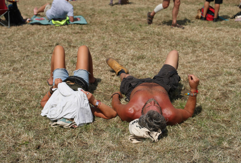 Festival goers sunbathe at the Glastonbury Festival, at Worthy Farm in Pilton, Somerset.