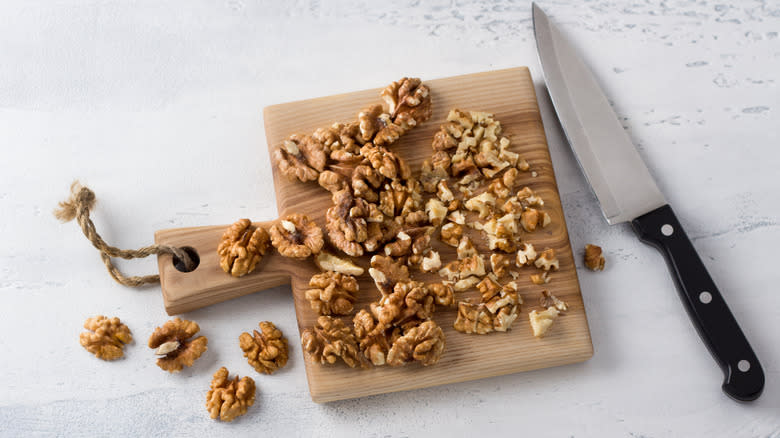 Chopped walnuts on board