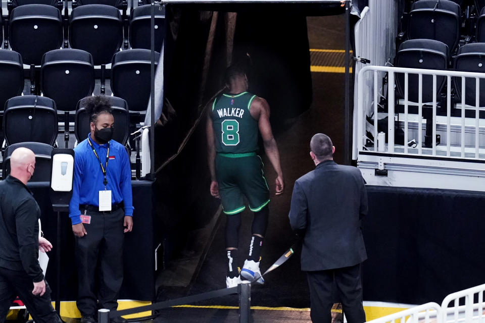 Boston Celtics guard Kemba Walker (8) heads to the locker room after an apparent injury early during the first quarter of the team's NBA basketball game against the Miami Heat, Tuesday, May 11, 2021, in Boston. (AP Photo/Charles Krupa)