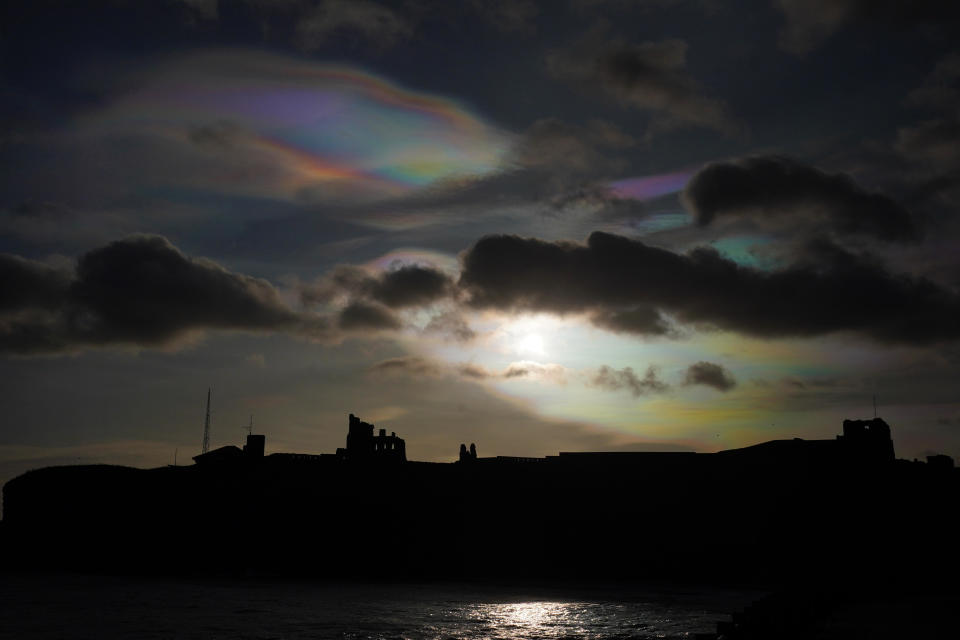 Rare nacreous clouds, known as rainbow clouds, form in the skies over Tynemouth Priory in the northeast of England on Dec. 21, 2023. / Credit: Owen Humphreys/PA Images via Getty Images