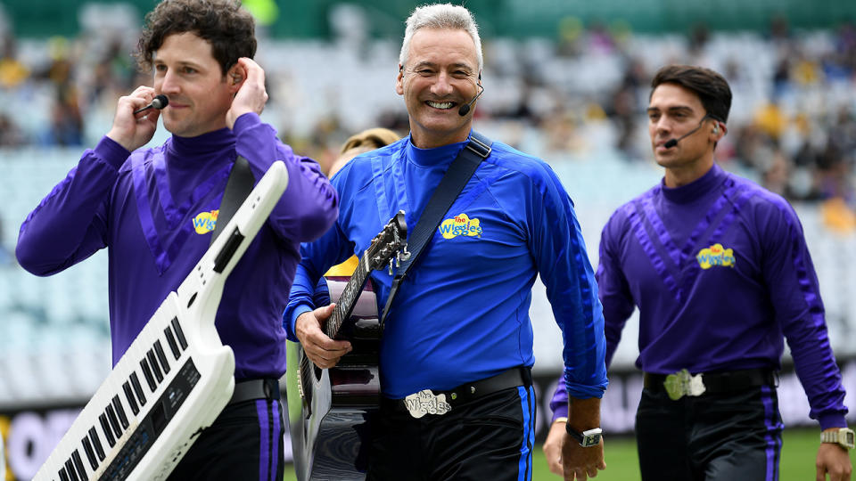 Anthony Field is pictured walking between Wiggles bandmates.