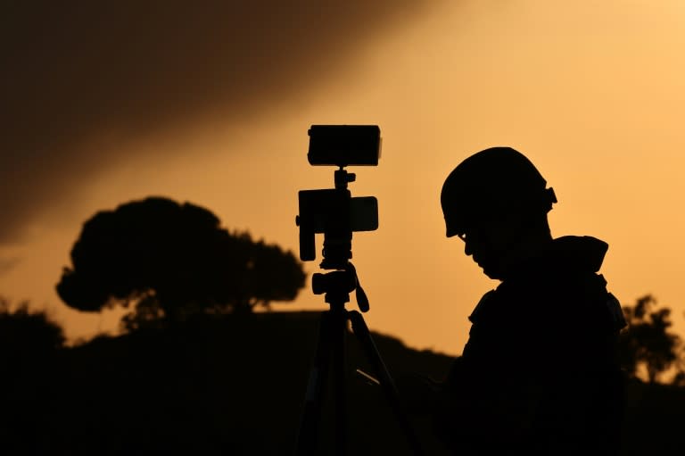 A member of the media stands behind his camera at a spot overlooking the Gaza Strip in the southern Israeli city of Sderot in a file picture taken on October 26, 2023 (Jack Guez)