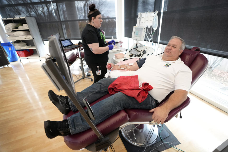 Matt Schermerhorn talks with nurse Nicole Wagner as he donates blood at the Impact Life blood center, Friday, Nov. 11, 2022, in Davenport, Iowa. Schermerhorn, 58, is among thousands of current and former military members and civilians who have returned to blood centers across the country after federal health officials lifted a longstanding ban this spring. “It’s a responsibility. It’s a civic duty,” said Schermerhorn, who donated on Veterans Day at the ImpactLife center in Davenport. “You don’t really have to go out of your way too much to help your fellow man.” (AP Photo/Charlie Neibergall)