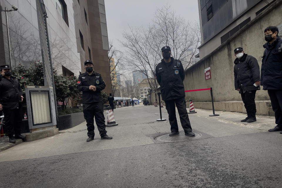 Security personnel stand watch outside the barricaded Sichuan Trust office building in Chengdu in southwestern China's Sichuan Province on Feb. 27, 2024. Some investors in a troubled trust fund in China are facing financial ruin under a government plan to return a fraction of their money, casualties of a slump in the property industry and a broader economic slowdown. (AP Photo/Andy Wong)