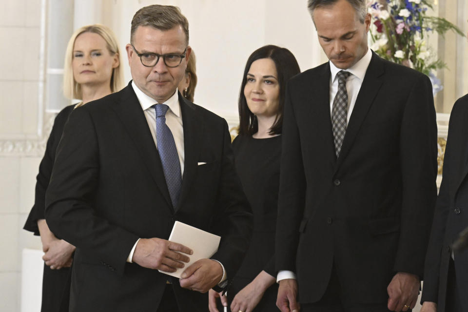 Finland's new Prime Minister Petteri Orpo, left, stands with some of his cabinet members,on the occasion of a complimentary visit to President of Finland Sauli Niinisto at the Presidential Palace in Helsinki, Finland, Tuesday June 20, 2023. (Jussi Nukari/Lehtikuva via AP)