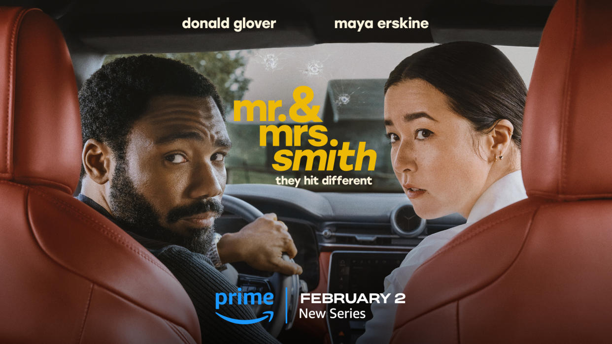 Donald Glover, Maya Erskine are sat in a car, looking into the backseat.