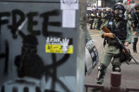 FILE - A riot police stands watch on the pro-democracy protesters during a rally in Hong Kong on Dec. 1, 2019. (AP Photo/Ng Han Guan, File)