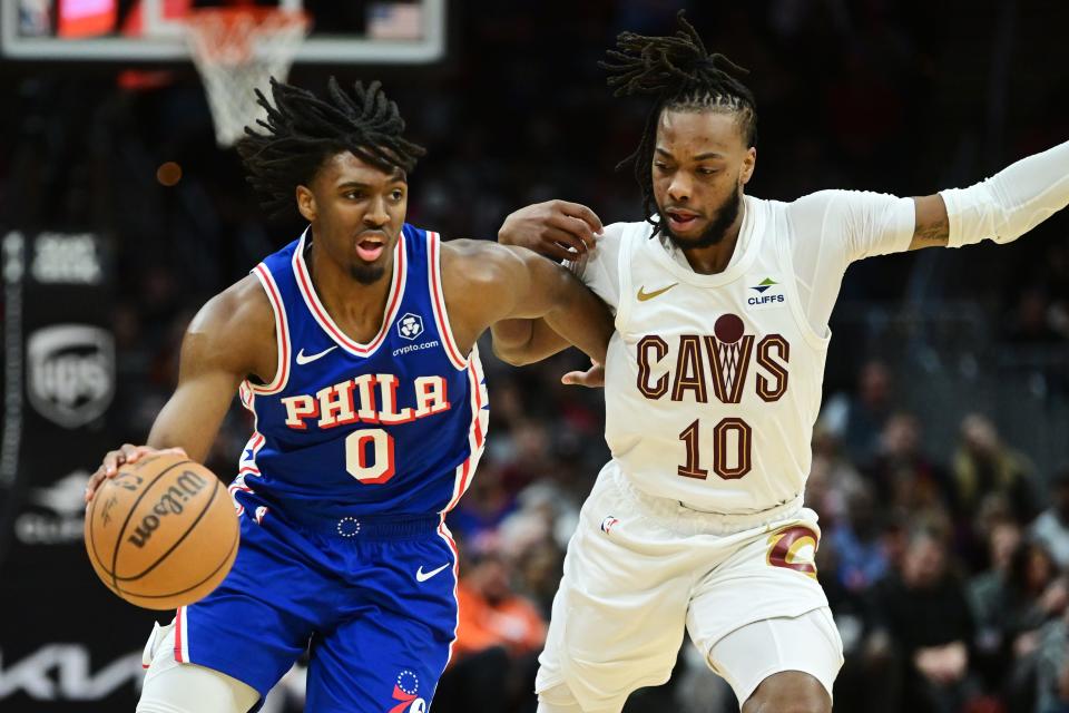 Mar 29, 2024; Cleveland, Ohio, USA; Philadelphia 76ers guard Tyrese Maxey (0) drives to the basket against Cleveland Cavaliers guard Darius Garland (10) during the first half at Rocket Mortgage FieldHouse. Mandatory Credit: Ken Blaze-USA TODAY Sports