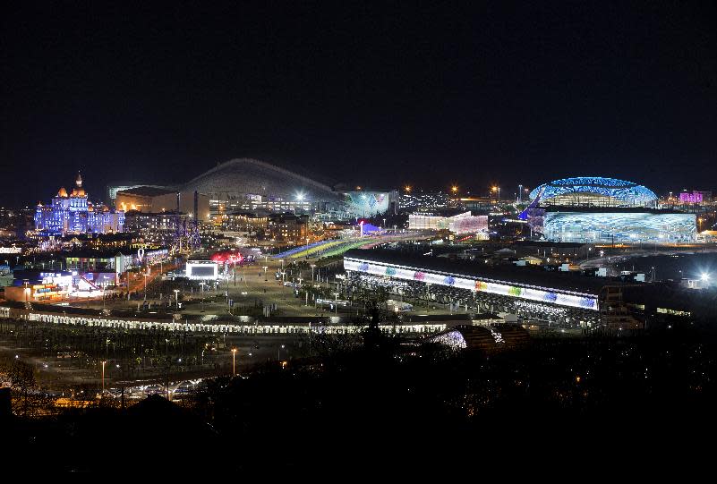 The Olympic Park is illuminated early Thursday morning, Feb. 6, 2014, in Sochi, Russia, prior to the start of the 2014 Winter Olympics. (AP Photo/Pavel Golovkin)