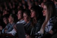 The audience watches CEO Tim Cook speaking at an Apple event at their headquarters in Cupertino