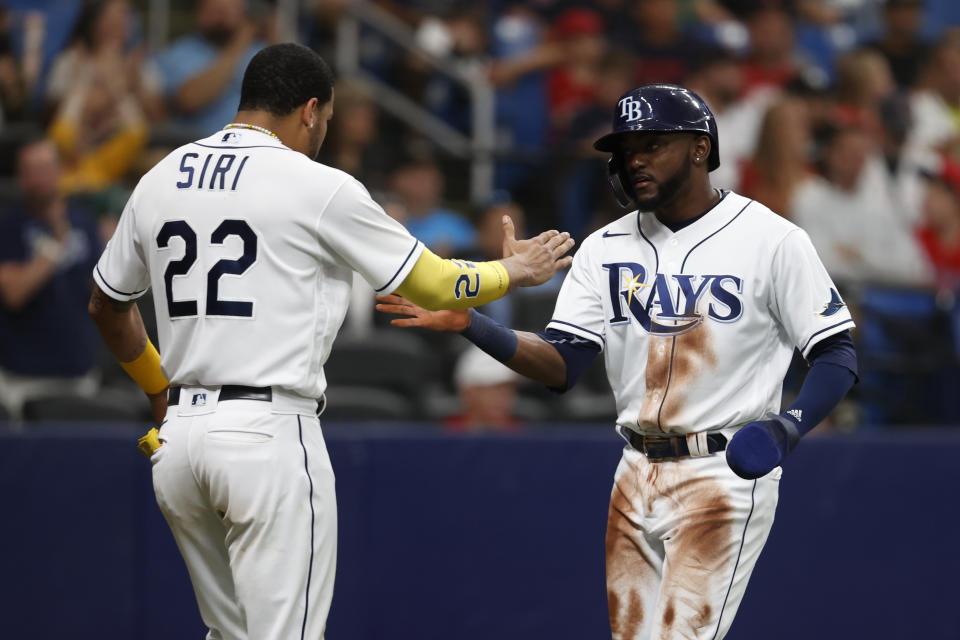 Tampa Bay Rays' Vidal Brujan, right, celebrates with Jose Siri after scoring against the Boston Red Sox during the seventh inning of a baseball game Monday, Sept. 5, 2022, in St. Petersburg, Fla. (AP Photo/Scott Audette)