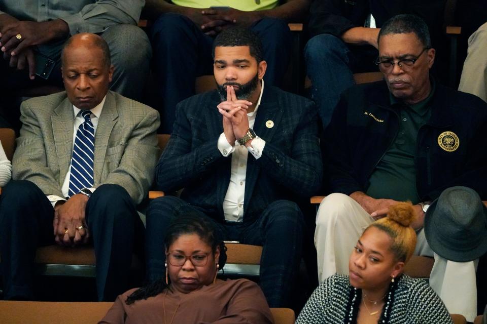 Jackson Mayor Chokwe Antar Lumumba, center, sits with staff as he watches lawmakers debate House Bill 1020, which would create a separate court system in the Capitol Complex Improvement District, Tuesday, Feb. 7, 2023, at the Mississippi Capitol in Jackson. (AP Photo/Rogelio V. Solis)