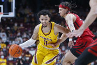 Minnesota guard Payton Willis (0) works around Rutgers guard Caleb McConnell (22) in the first half of an NCAA college basketball game Saturday, Jan. 22, 2022, in Minneapolis. (AP Photo/Bruce Kluckhohn)