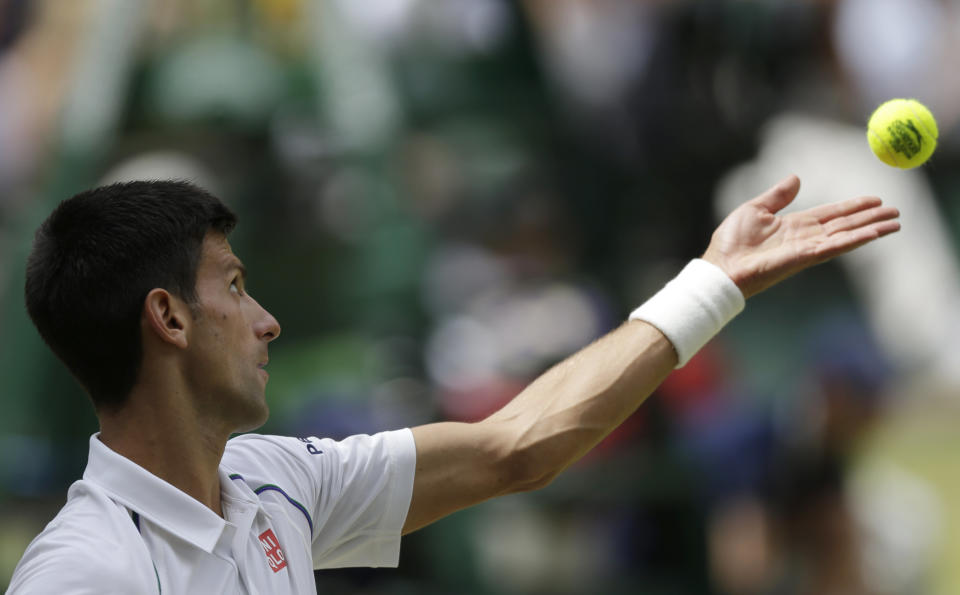 Novak Djokovic of Serbia serves to Roger Federer of Switzerland during the men's singles final at the All England Lawn Tennis Championships in Wimbledon, London, Sunday July 12, 2015. (AP Photo/Pavel Golovkin)