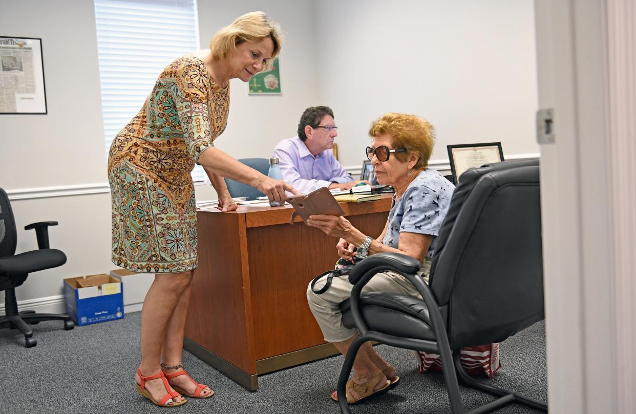 Here Diana Grandy, a ERAP Specialist, Sarasota County's Emergency Rental Assistance program, helps out  89-year-old Edith Marcus, on right, with a email on her phone as Phil Heller the housing navigator with Gulfcoast Legal Services works on her case. Edith was called by a leasing consultant at The Reserve at Palmer Ranch Apartments in Sarasota who informed her that her signed-for apartment would no longer be held for her — 72 hours before she was set to move in.