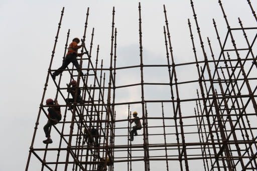 Chinese labourers work at a construction site in Hefei, in eastern China's Anhui province. China's annual growth slowed to 9.2 percent last year from 10.4 percent in 2010, prompting the government to cut its economic growth target to 7.5 percent this year, in an official acknowledgement that the export-driven economy is slowing