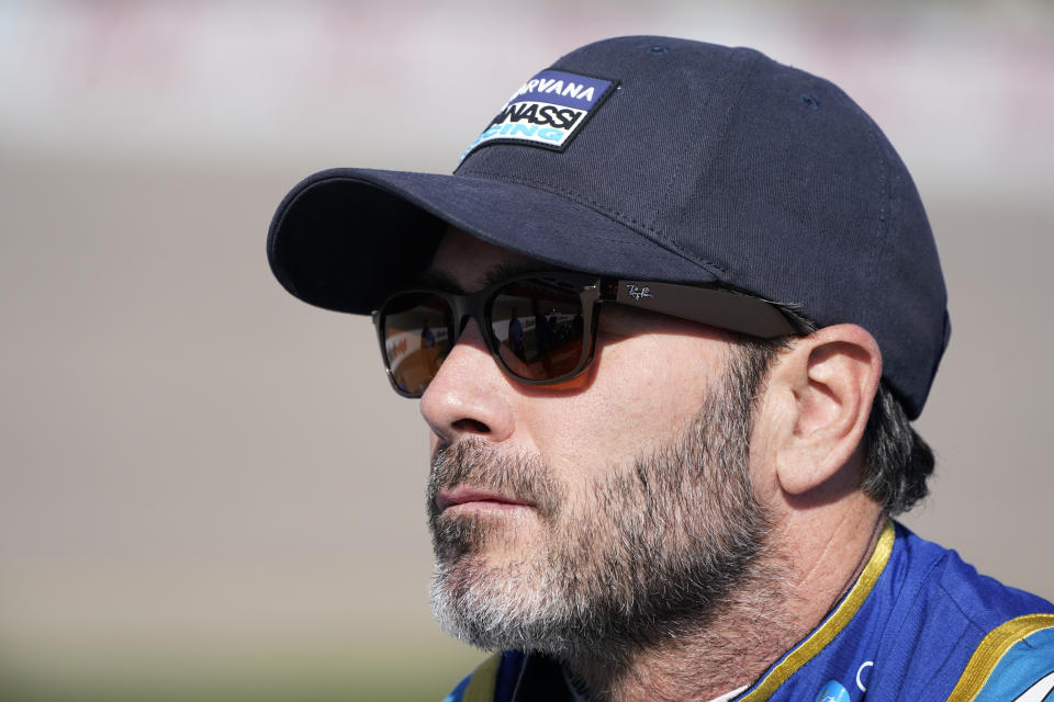 Jimmie Johnson stands near his car during qualifying for an IndyCar Series auto race, Saturday, July 23, 2022, at Iowa Speedway in Newton, Iowa. (AP Photo/Charlie Neibergall)