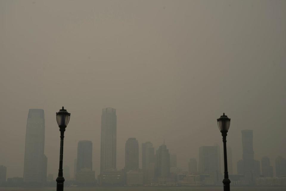 Buildings in Jersey City are partially obscured by smoke (Patrick Sison)