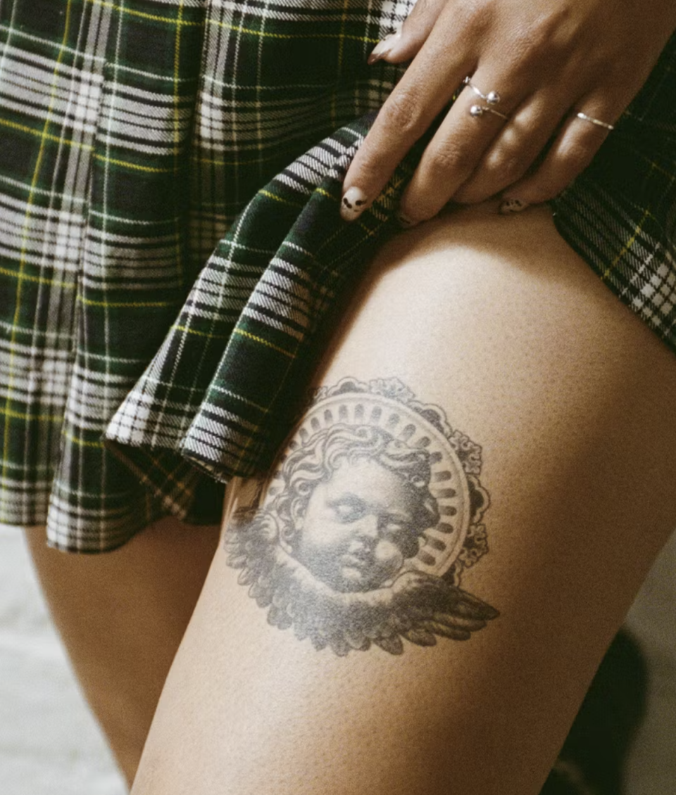 model wearing thigh temporary tattoo of angel cherub 