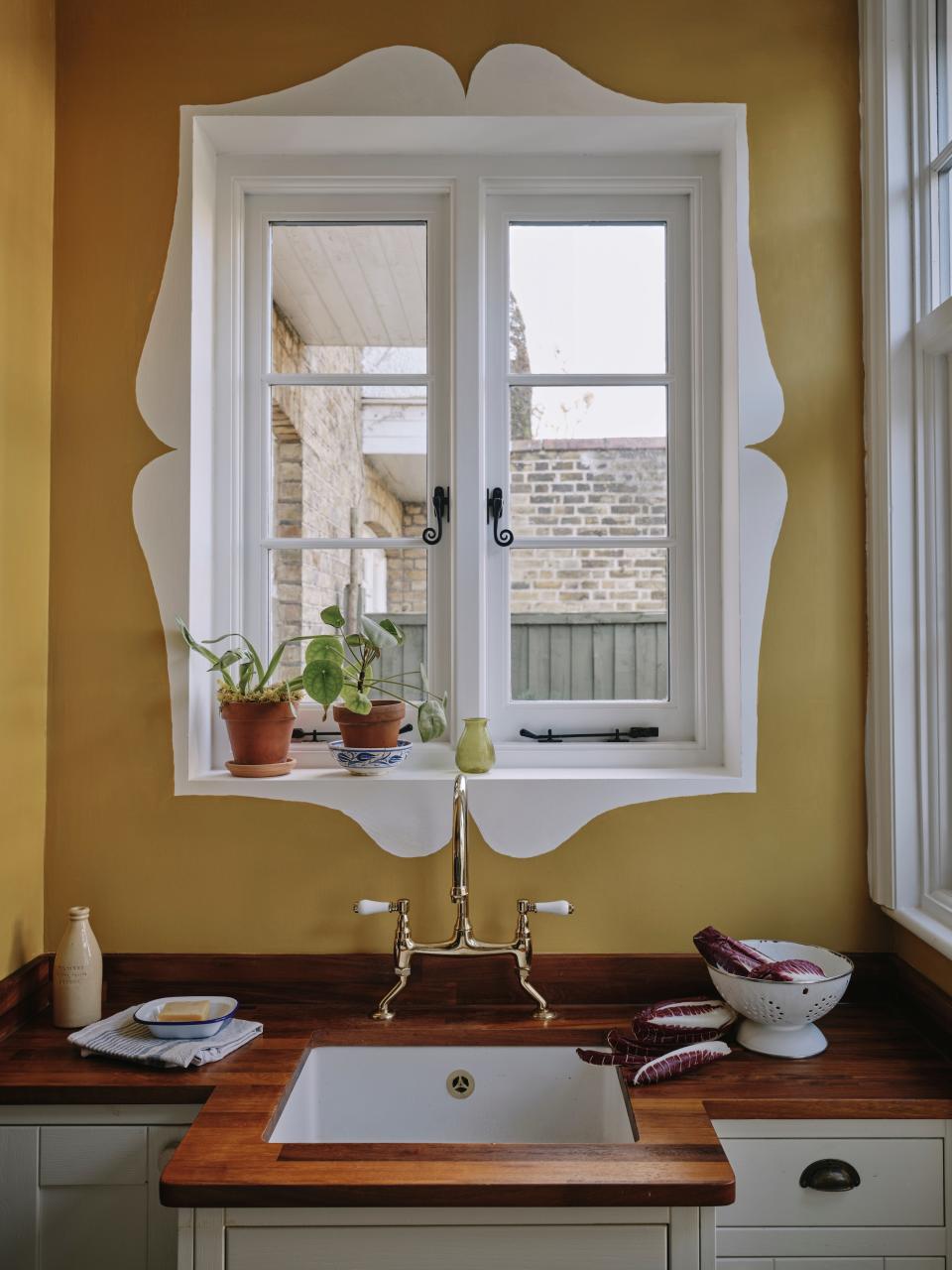 “My favorite part of the kitchen is probably the new window and sink. After we installed it, I was wondering about how to make the window more interesting and had the idea of painting something around it. This shape was inspired by a recent trip to Barcelona, where I saw plenty of painted window surrounds,” avers James