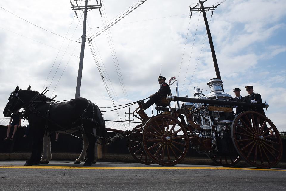 A silhouette of a horse-drawn fire engine at the Boonton parade in Boonton on Saturday September 1, 2018. 