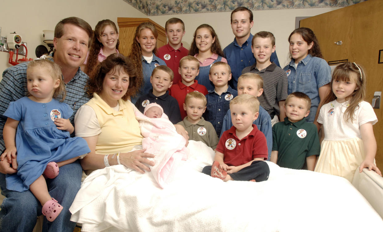 FILE -- In this Aug. 2, 2007 file photo, Michelle Duggar, left, poses with her husband Jim Bob, second from left, and children, including their oldest son Josh, tallest standing, after the birth of her 17th child in Rogers, Ark. Calling himself 