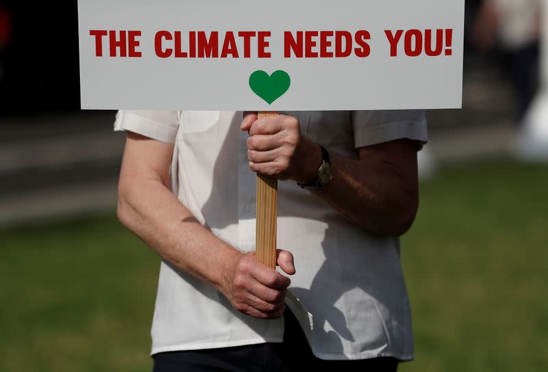 FILE PHOTO: Climate Coalition protesters demonstrate 100 days ahead of the COP26 climate summit, in London