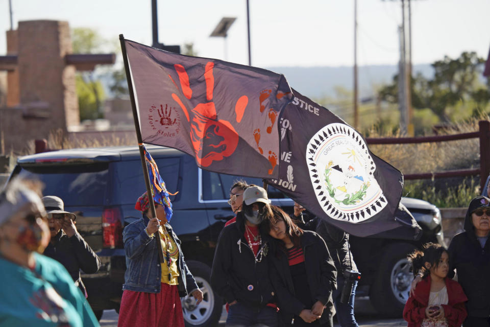 A Missing and Murdered Indigenous Women banner is carried by Muzzy Denetso, left, during a MMIW Honor and Remembrance Walk on Friday, May 5. 2023, in Window Rock, Ariz. on the Navajo Nation. (Donovan Quintero/Navajo Nation Office of the President and Vice President)