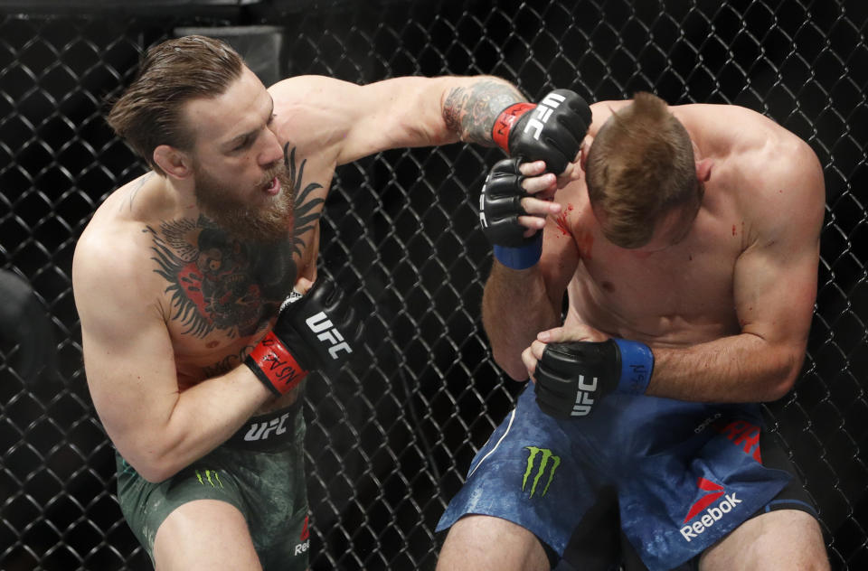 Conor McGregor hits Donald "Cowboy" Cerrone during a UFC 246 welterweight mixed martial arts bout Saturday, Jan. 18, 2020, in Las Vegas. (AP Photo/John Locher)