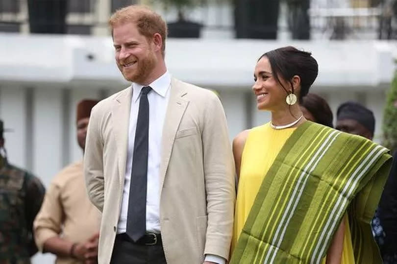 Prince Harry and Meghan Markle holding hands.