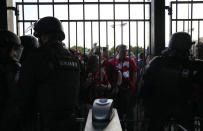 Liverpool fans wait in front of the of the Stade de France prior the Champions League final soccer match between Liverpool and Real Madrid, in Saint Denis near Paris, Saturday, May 28, 2022. (AP Photo/Christophe Ena)