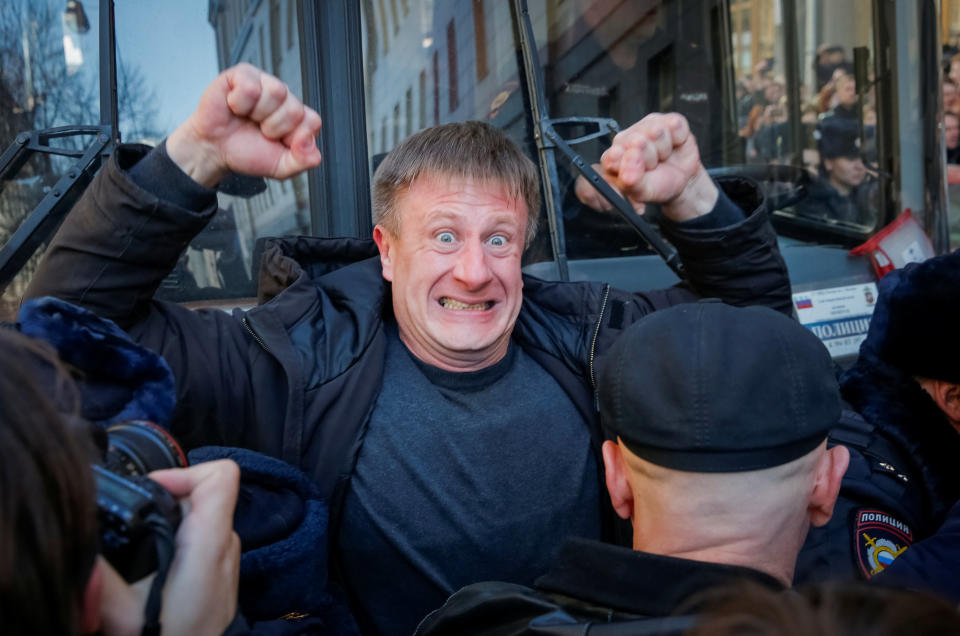 An opposition supporter blocks a police van transporting Navalny during a rally in Moscow.