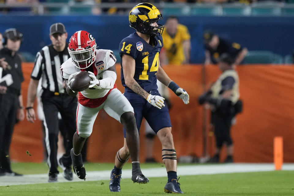 Georgia defensive back Derion Kendrick intercepts a pass intended for Michigan wide receiver Roman Wilson during the first half of the Orange Bowl NCAA College Football Playoff semifinal game, Friday, Dec. 31, 2021, in Miami Gardens, Fla. (AP Photo/Rebecca Blackwell)