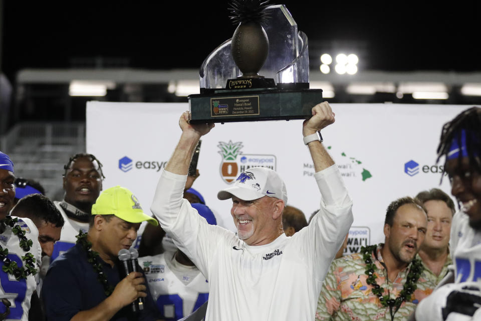 Middle Tennessee head coach Rick Stockstill lifts the winning trophy at the Hawaii Bowl NCAA college football game after the team defeated San Diego State, Saturday, Dec. 24, 2022, in Honolulu. (AP Photo/Marco Garcia)