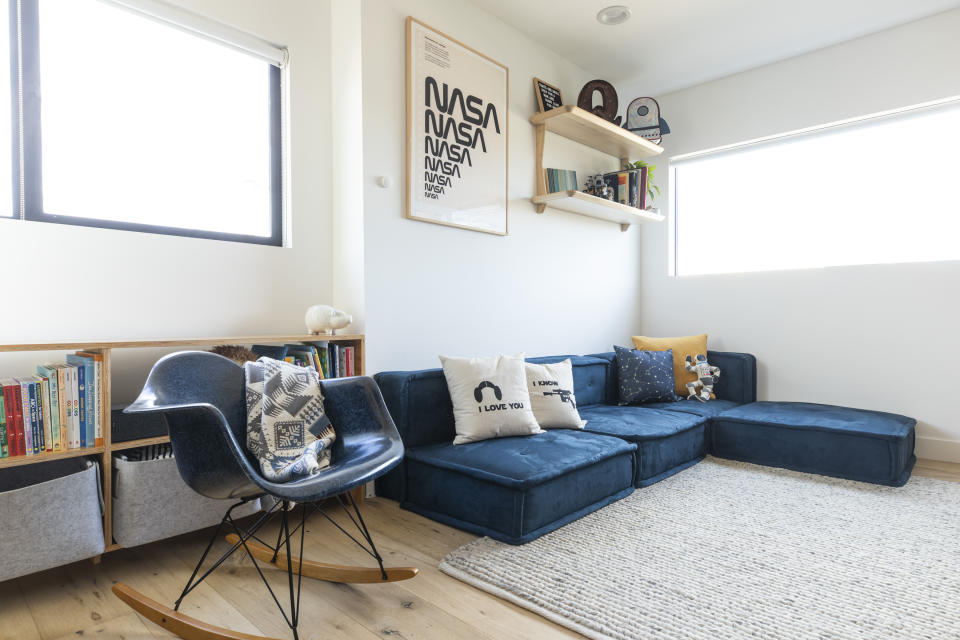 This image provided by Fernish shows an outer space inspired child's bedroom. Rachel Magana, senior visual designer at the sustainable furniture-rental company Fernish, says she picked up some cosmological decorating ideas from a colleague's recent nursery project. She suggests adding fun, space-agey lamps, and vintage NASA posters. (Dustin Walker Photography/Fernish via AP)