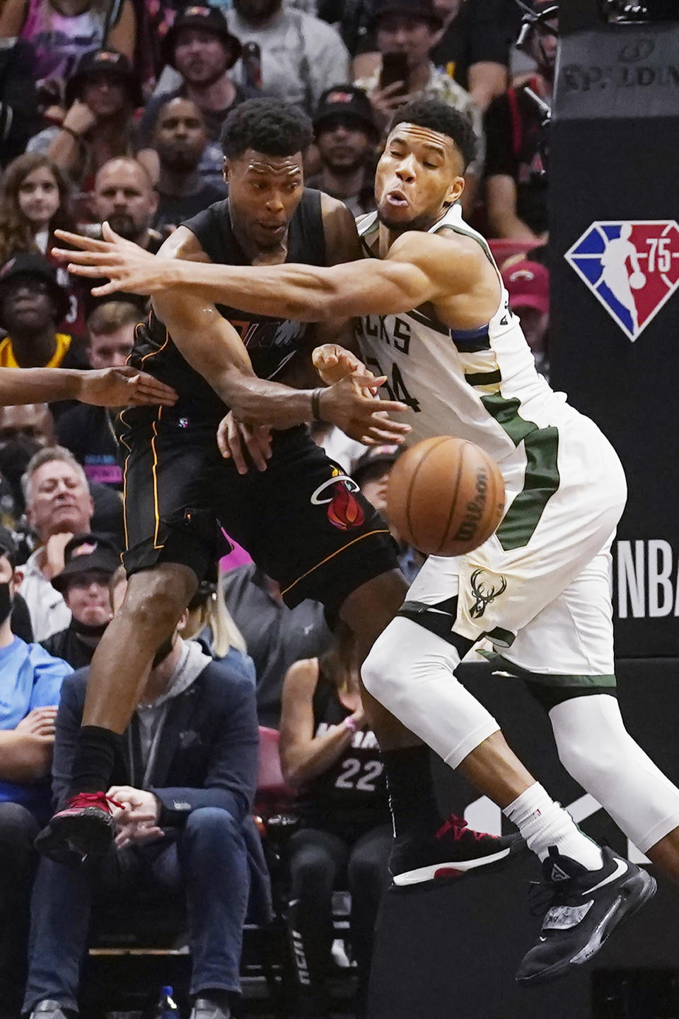 Miami Heat guard Kyle Lowry (7) passes the ball under pressure from Milwaukee Bucks forward Giannis Antetokounmpo during the second half of an NBA basketball game, Wednesday, Dec. 8, 2021, in Miami. The Heat defeated the Bucks 113-104. (AP Photo/Marta Lavandier)