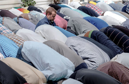 Australian journalist Dean Yates sits with Muslims as they pray at the Elsedeaq Heidelberg Mosque, located in the Melbourne suburb of Heidelberg in Australia, March 2, 2018. Picture taken March 2, 2018. REUTERS/Luis Enrique Ascui