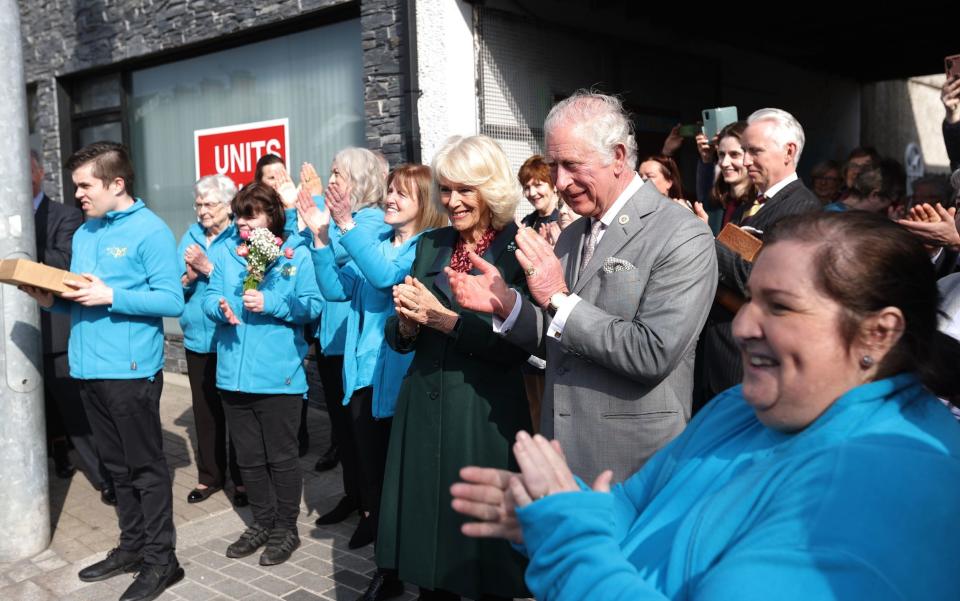 The Prince of Wales and the Duchess of Cornwall enjoy a dance performance outside the Superstars Cafe in Cookstown - Liam McBurney/PA