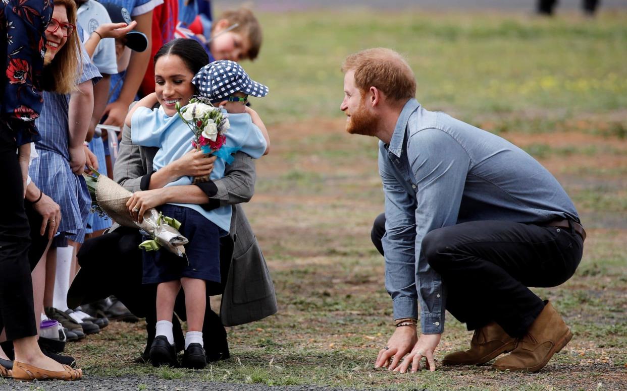 Five-year-old Luke Vincent give the Duchess a big hug as the royal couple arrive at Dubbo Airport - REUTERS