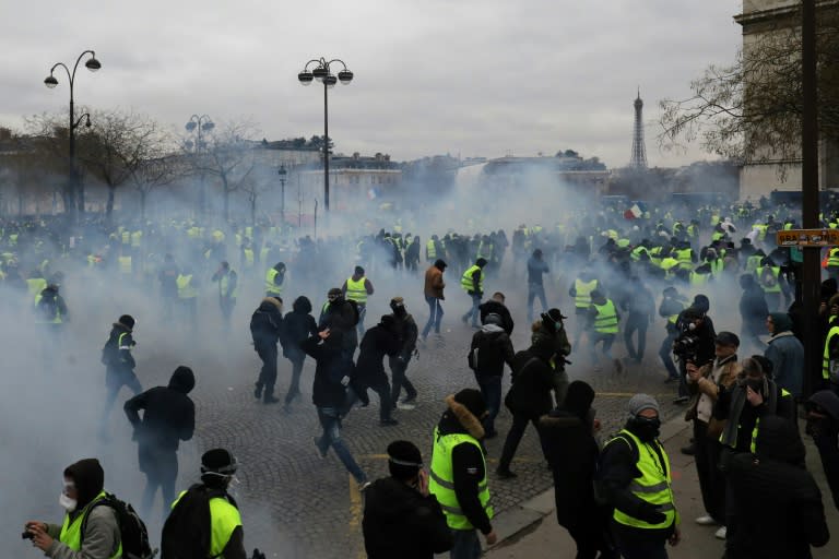 Police fired tear gas and water cannon to disperse advancing "yellow vest" protesters at the Arc de Triomphe in Paris on Saturday