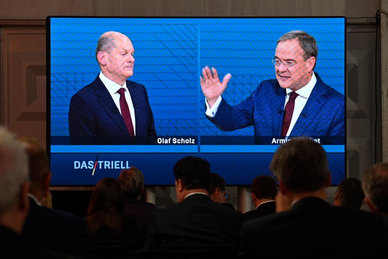 Journalists and party members watch on a screen from the press centre (L-R) Olaf Scholz, German Finance Minister, Vice-Chancellor and the Social Democrats (SPD) candidate for Chancellor and Armin Laschet, North Rhine-Westphalia's State Premier and the Christian Democratic Union (CDU) candidate for Chancellor as they attend an election TV debate in Berlin on September 12, 2021, ahead of general elections taking place on September 26, 2021. (Photo by John MACDOUGALL / AFP) (Photo by JOHN MACDOUGALL/AFP via Getty Images)