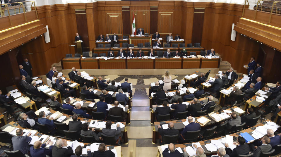 In this photo released by the Lebanese Parliament Media Office, Lebanese lawmakers attend a legislative session, at the Lebanese parliament building, in Beirut, Lebanon, Tuesday, Sept. 25, 2018. Lebanon's parliament has ratified the international Arms Trade Treaty, angering Hezbollah legislators, some of whom walked out in protest. After Lebanon's 15-year civil war ended in 1990, Hezbollah was allowed to keep its weapons since it was fighting Israeli forces who were occupying parts of southern Lebanon. (AP Photo/Ali Fawaz, Lebanese Parliament Media Office)
