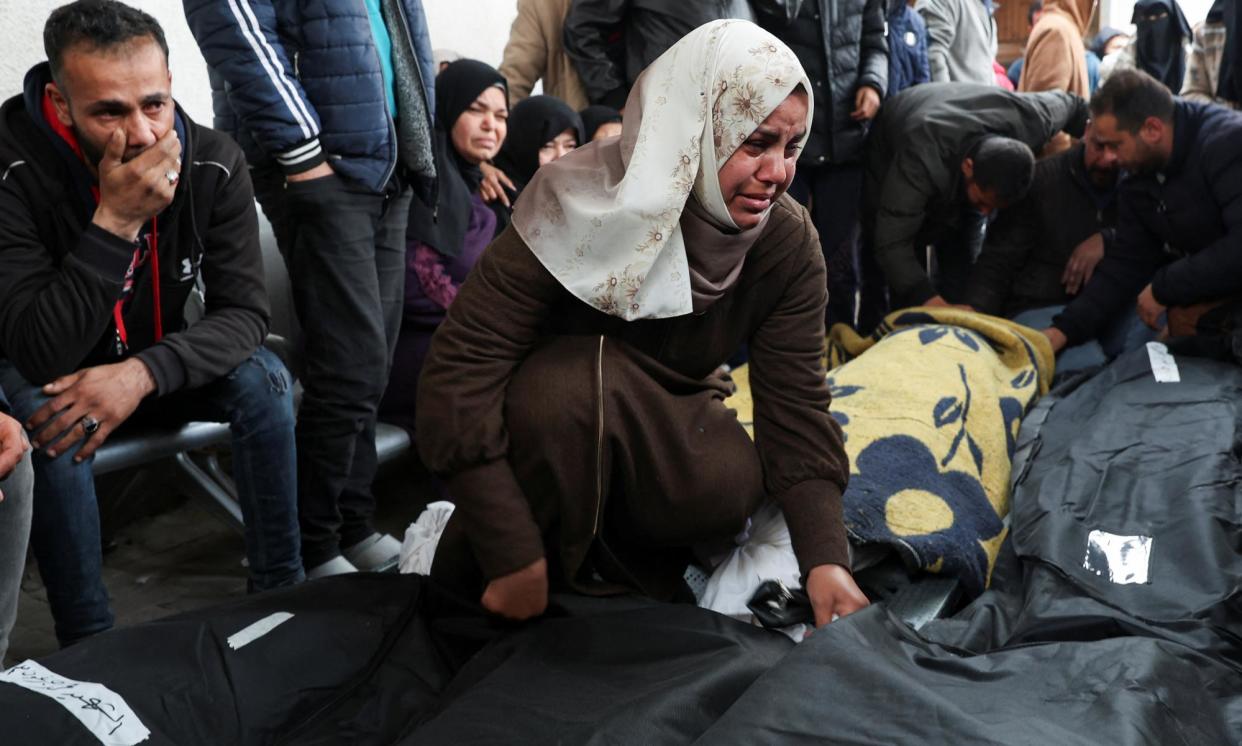 <span>Mourners react next to the bodies of Palestinians killed in Israeli strikes at Abu Yousef Al-Najjar hospital in Rafah in the southern Gaza Strip on 23 February.</span><span>Photograph: Ibraheem Abu Mustafa/Reuters</span>