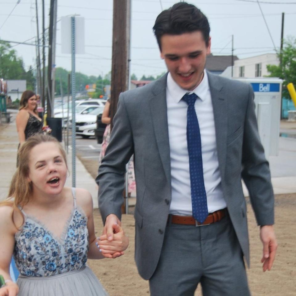 Gabby Horner-Shepherd, 21, who has Partial Trisomy 13, attended her Ontario senior prom with two men on her arm. (Photo: Courtesy of Alexandra Daiken)