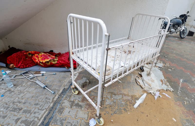 A wounded Palestinian man sleeps at Abu Yousef al-Najjar hospital, in Rafah